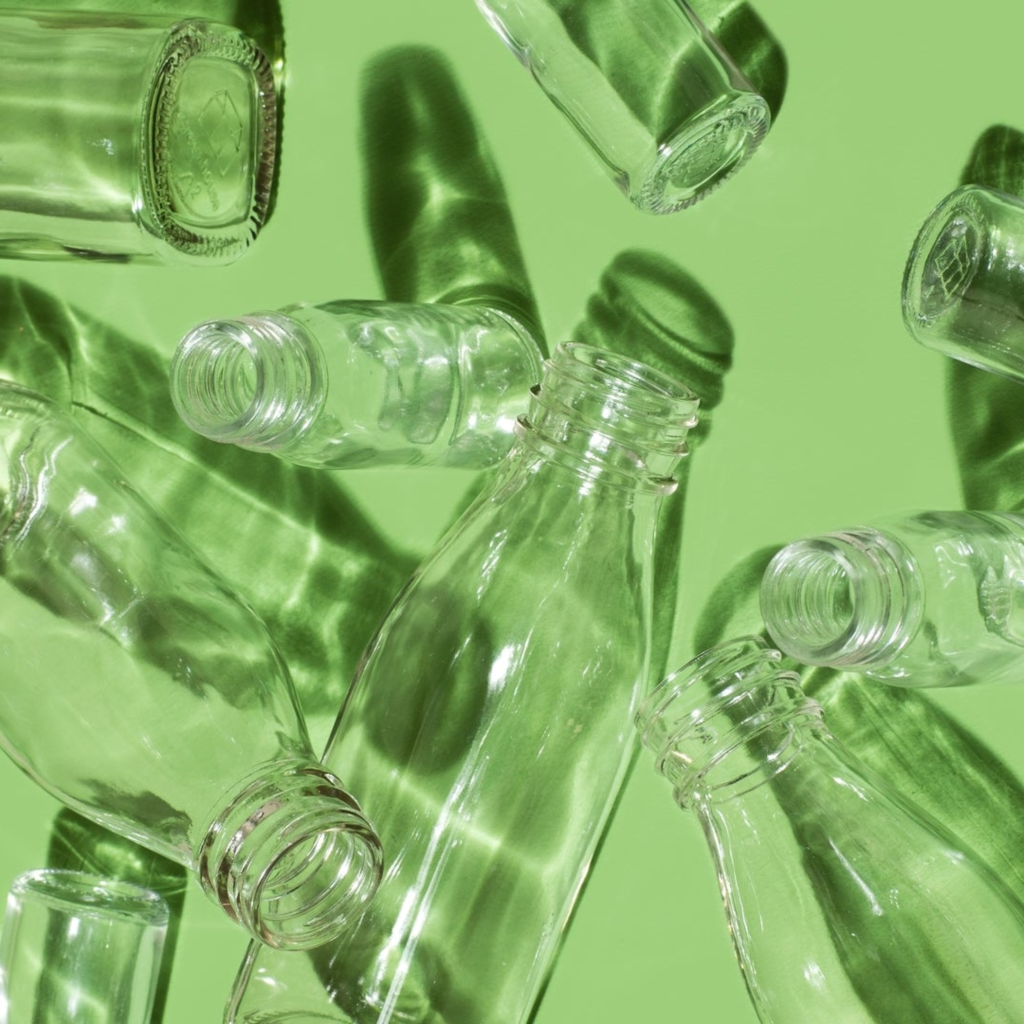 Several empty bottles on green background