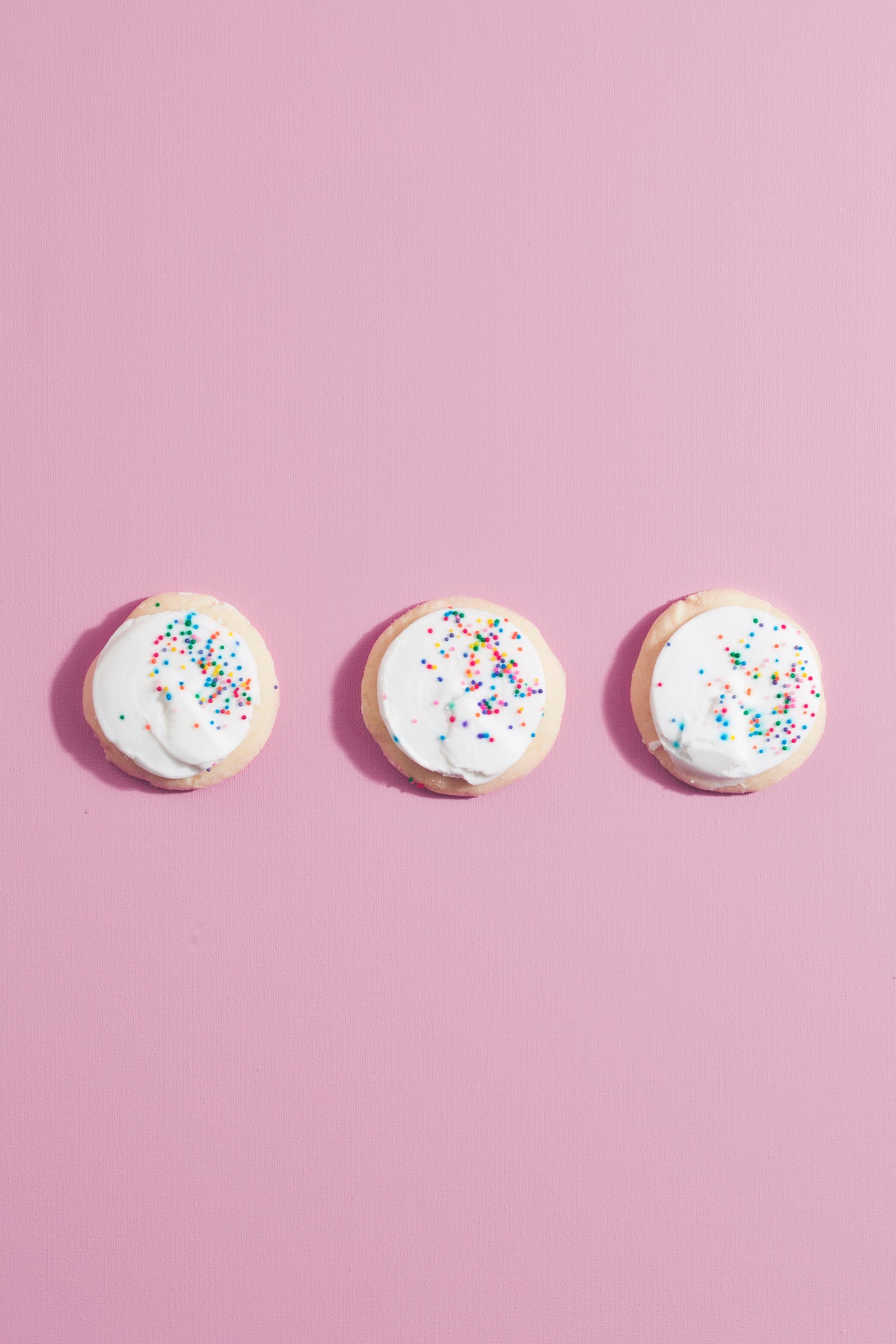 Three cookies on pink background